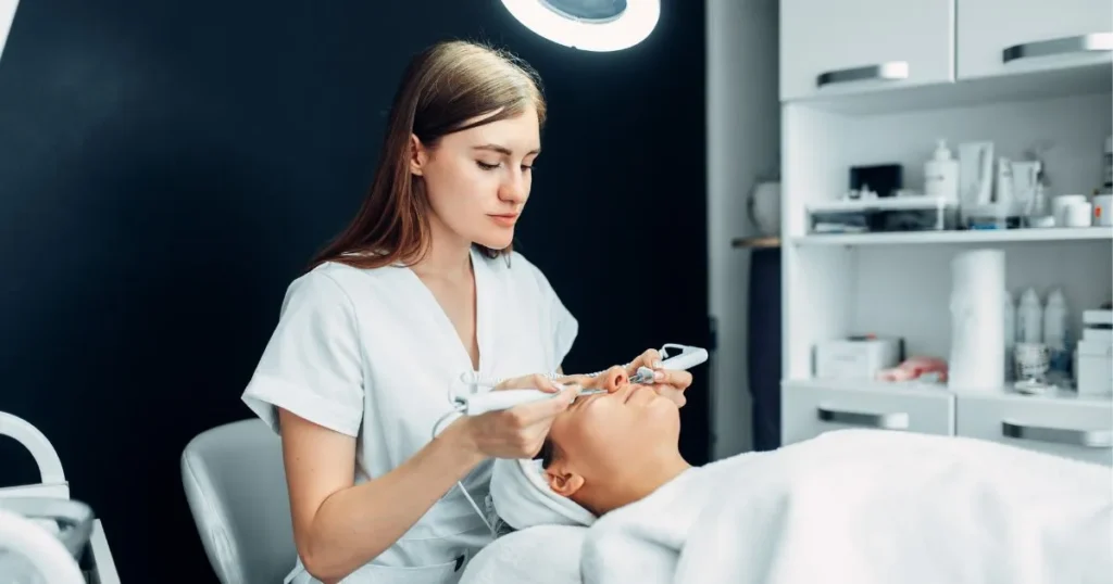 Aesthetician at Rejuve Med Spa performs a professional facial using skin tools