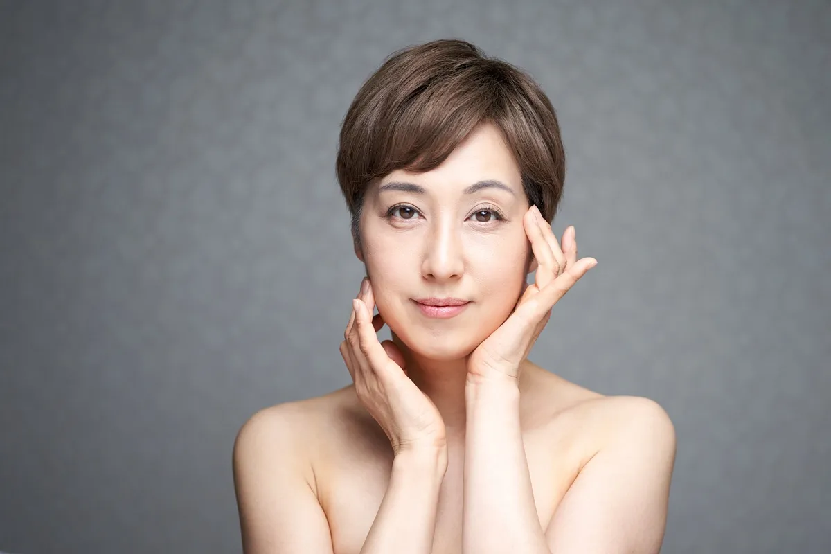 Beauty portrait of woman touching face gently