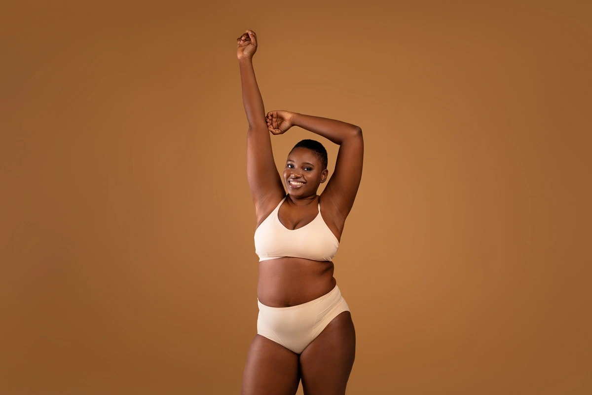 Woman showing toned body confidence in studio