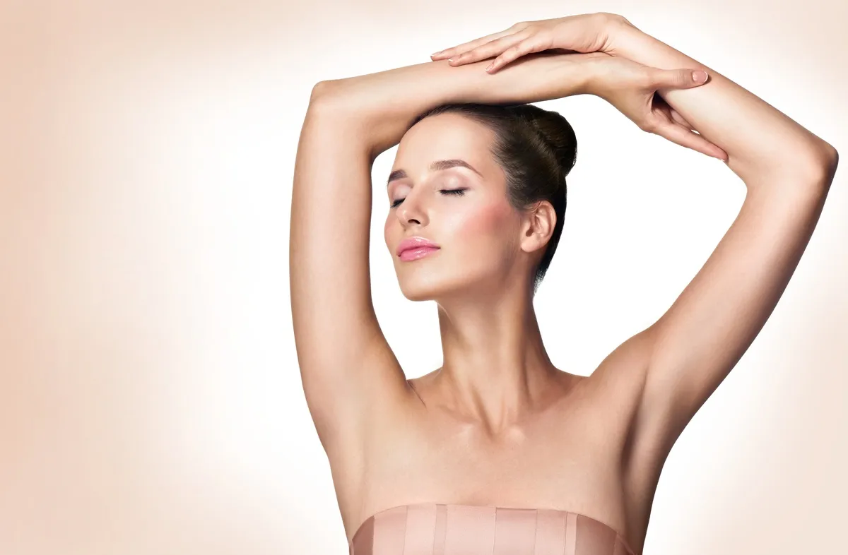 Woman posing with smooth underarm skin