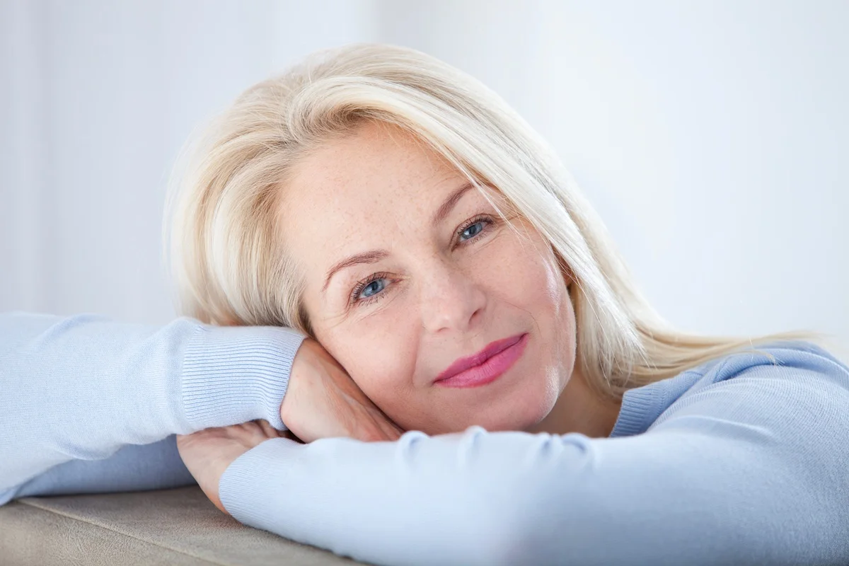 Mature woman smiling with healthy glowing complexion