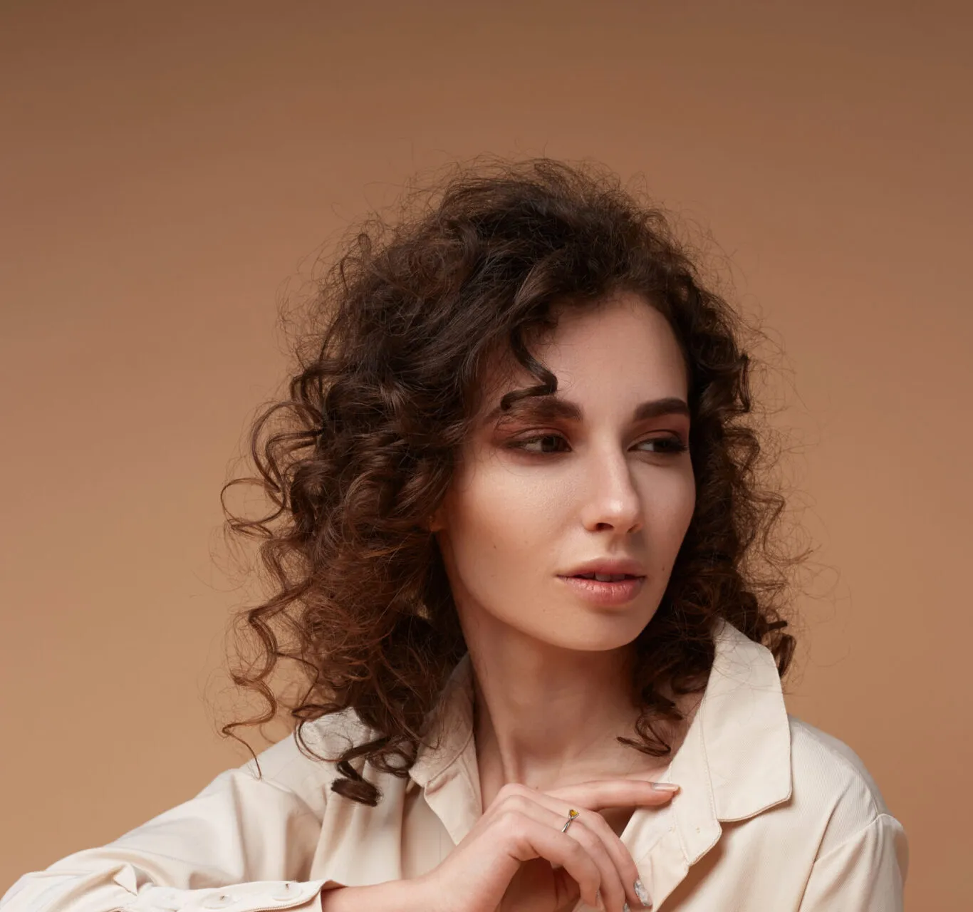 Curly-haired woman portrait with natural glowing skin