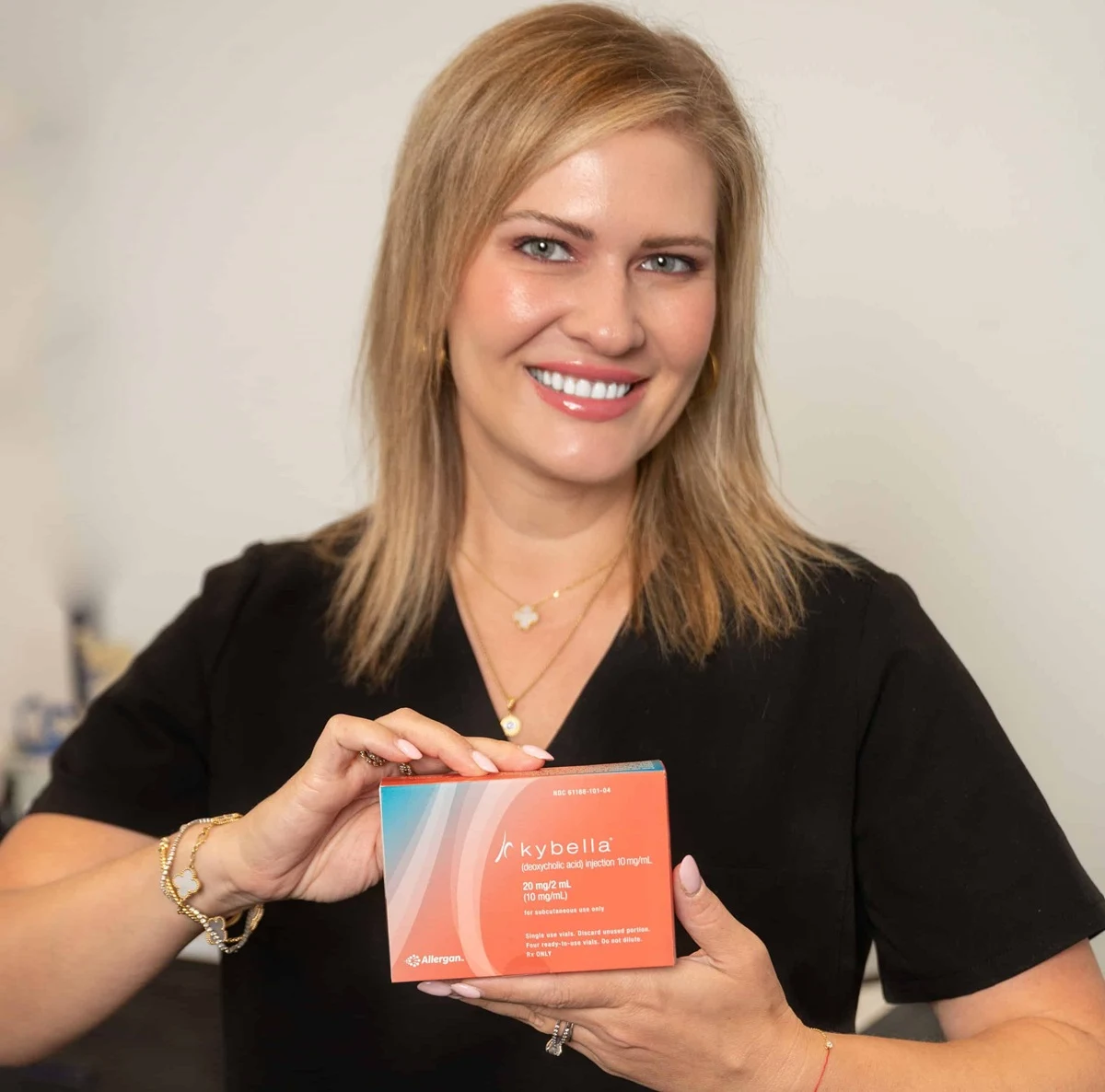 Aesthetic clinic professional holding skincare product box