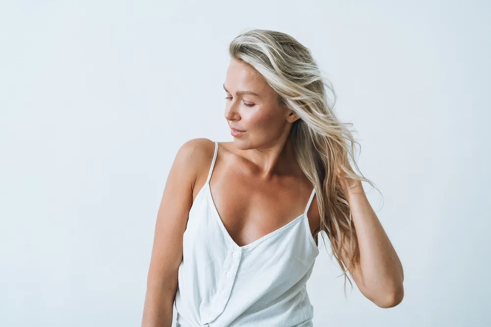 Woman enjoying healthy glowing skin after skincare routine