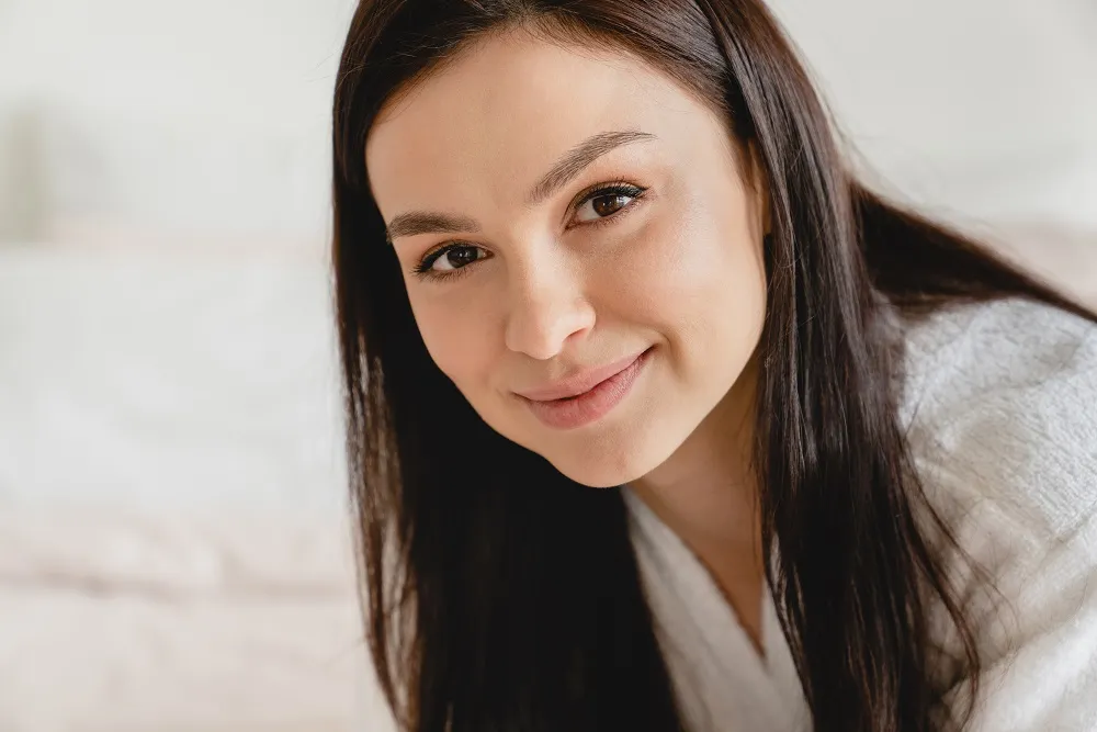 Woman with clear skin smiling confidently