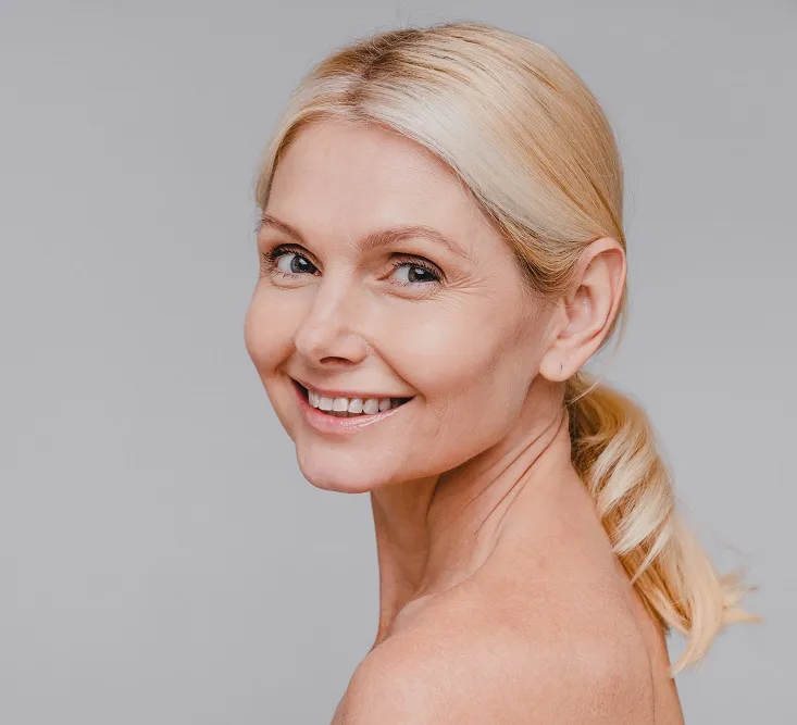 Mature woman showing anti-aging skin care results
