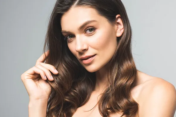 Woman with long shiny hair and radiant complexion