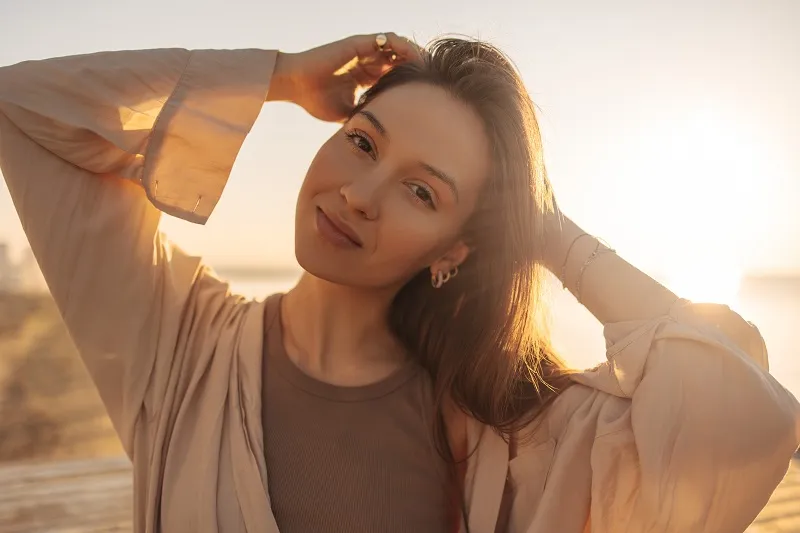 Woman enjoying sunlight with healthy glowing skin